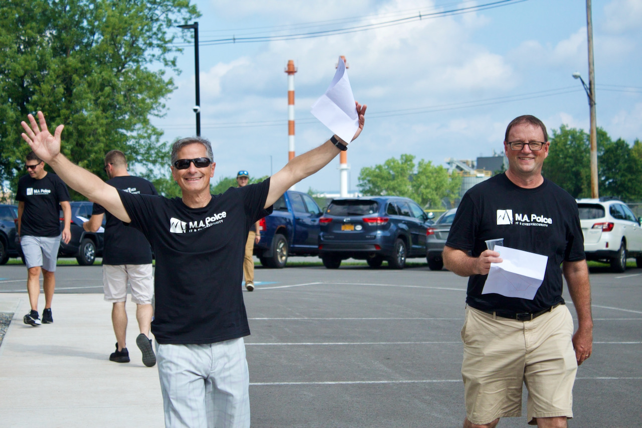 Two M.A. Polce employees participating in a team building activity to promote technology and cybersecurity job openings and careers in Central New York